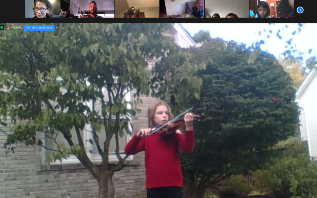 Zoom outdoor book recital of girl playing violin 1