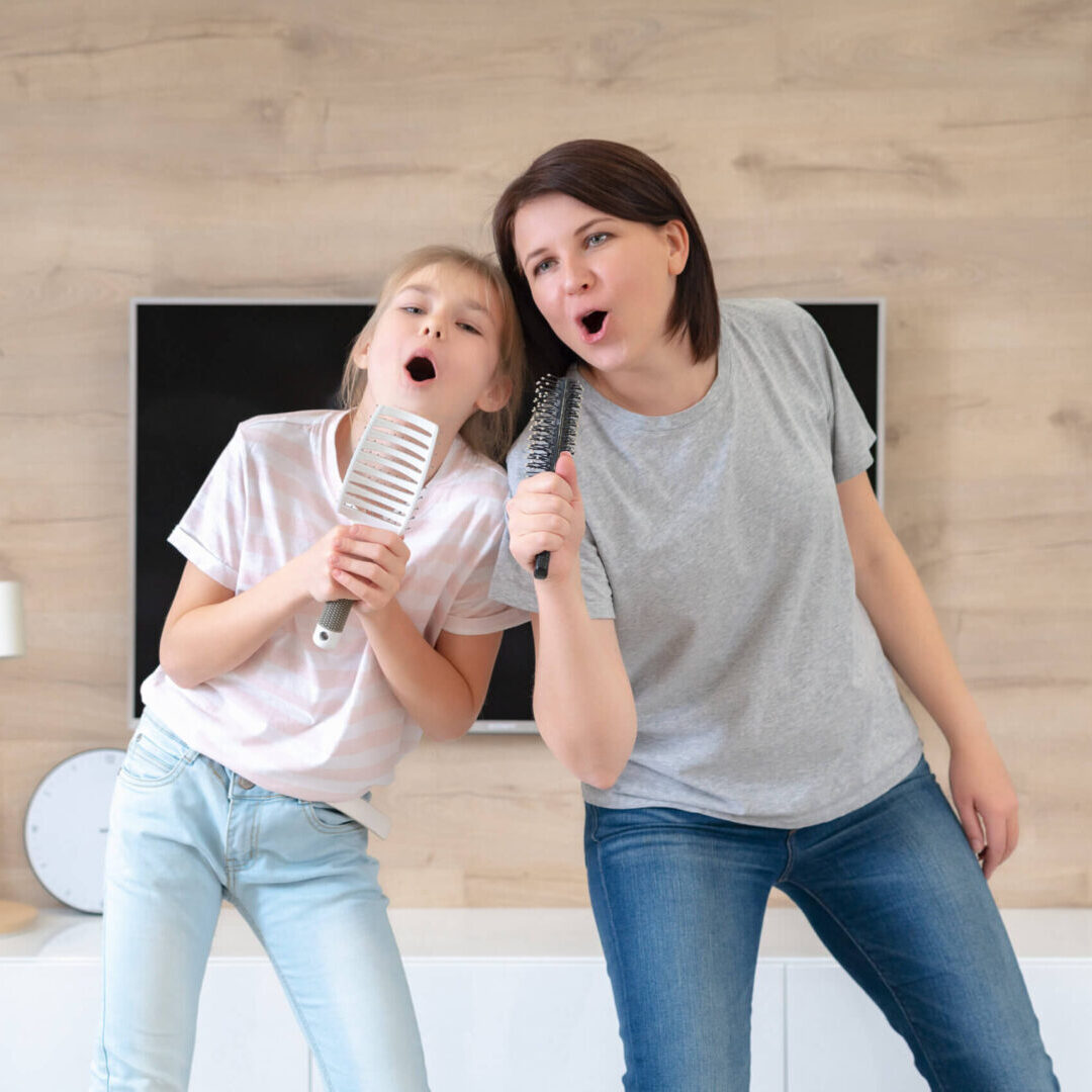 Mother and daughter singing at home